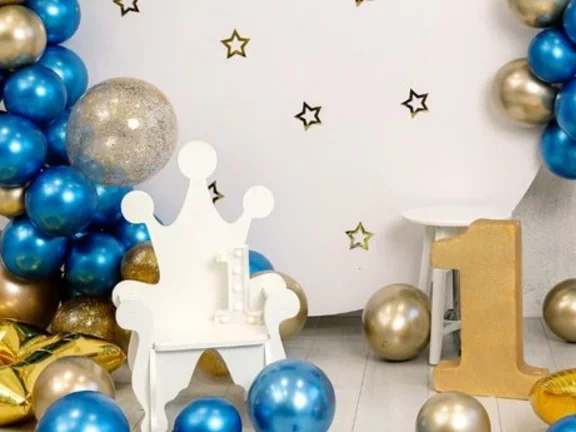 Decoração de festa infantil em tons dourados e com balões de gás hélio metalizados